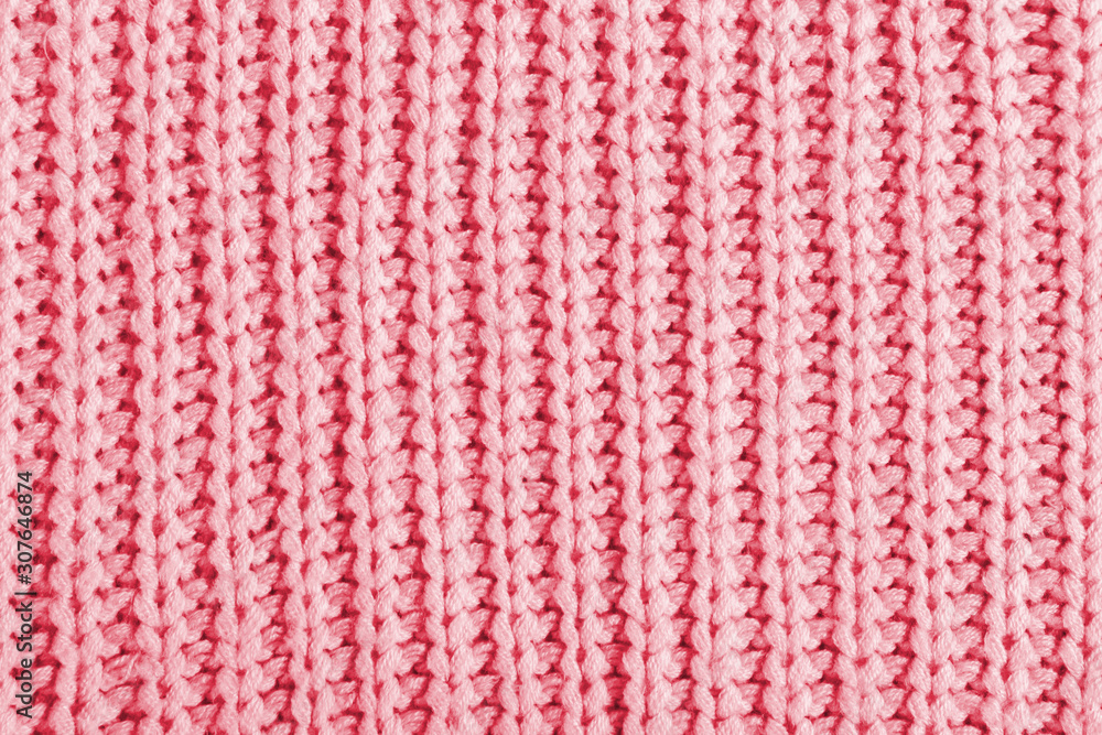 Pink texture of a large knit sweater. Knitted scarf background, winter cozy textile background