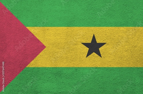 Sao Tome and Principe flag depicted in bright paint colors on old relief plastering wall. Textured banner on rough background photo