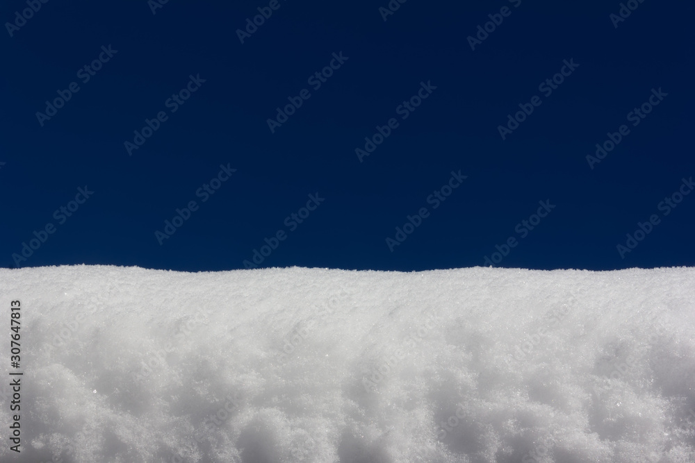 Fototapeta premium snowdrift on blue sky background close-up, with copy space