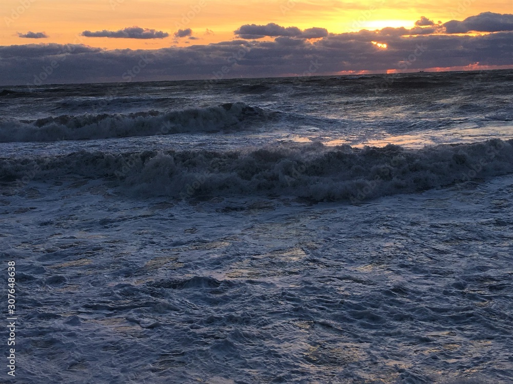 Sea with sunset with rocky beach and clouds Sea with sunset with rocky beach and clouds