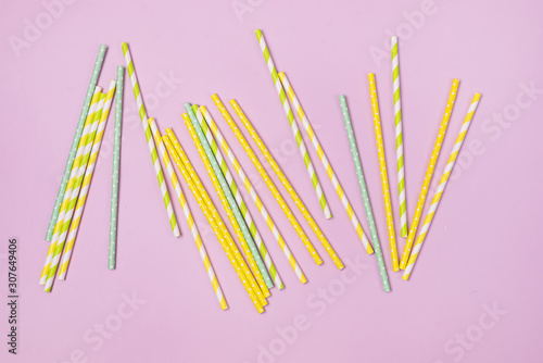 Striped Drink Straws of Different Colors on Pink Background Top View  Horizontal