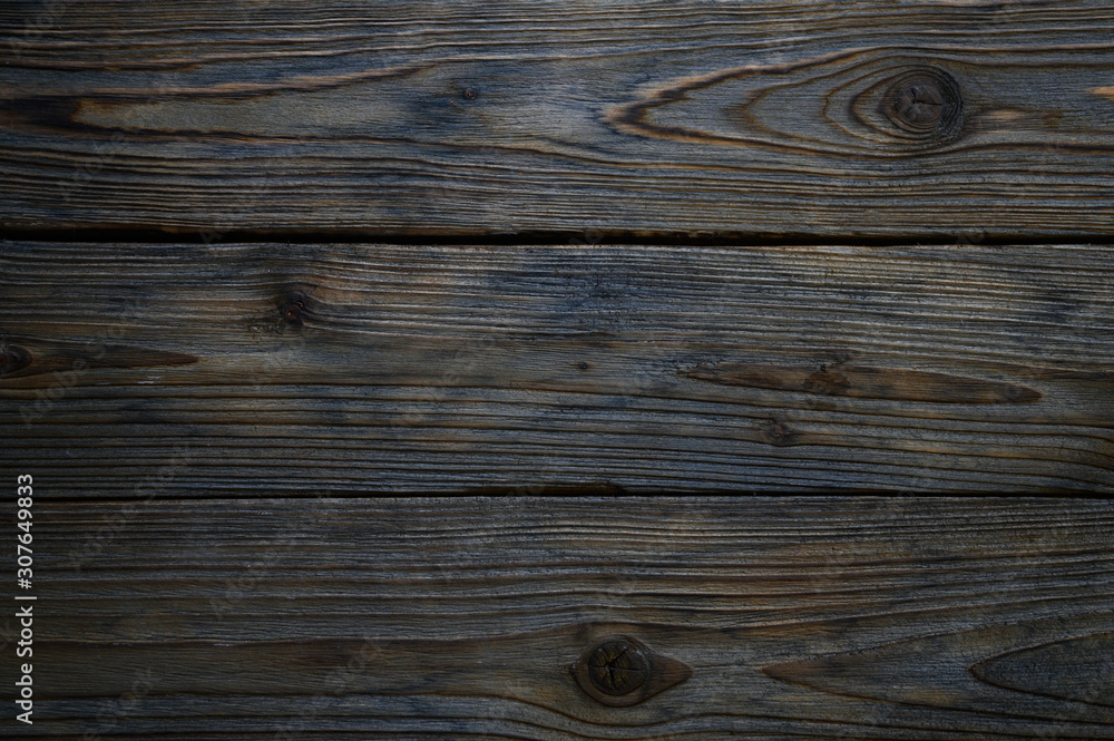 Fototapeta premium background of old shabby burned brown gray wooden boards