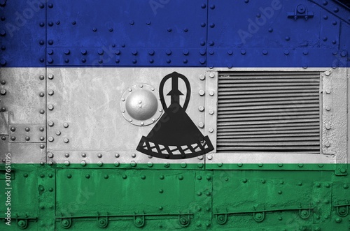 Lesotho flag depicted on side part of military armored tank closeup. Army forces conceptual background photo