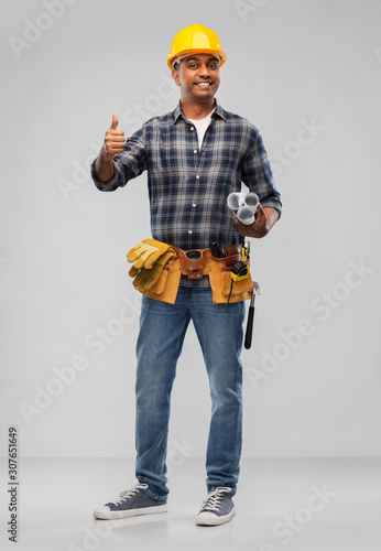 profession, construction and building - happy smiling indian builder in helmet with blueprint and clipboard over grey background