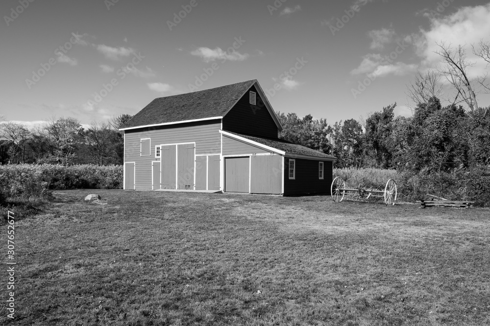 Isolated red barn in wooded area. Red farm barn building exterior. Isolated red barn in wooded area. Red farm barn building exterior.