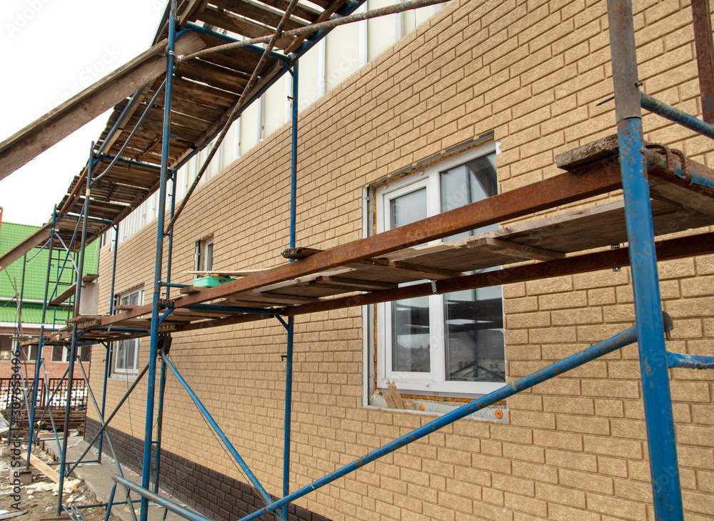 Fototapeta premium Installation of siding on the walls of the house