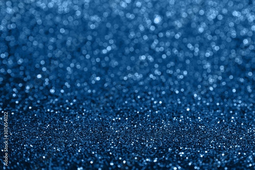 Abstract composition. Blue glitter light background with beautiful bokeh. Color of the year 2020