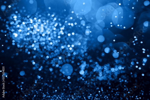 Blue abstract bokeh on black background. Holiday concept