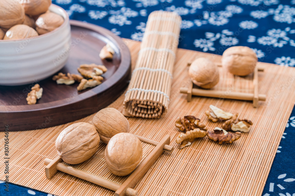 Chinese Xinjiang specialty walnuts and walnut kernels on bamboo mats