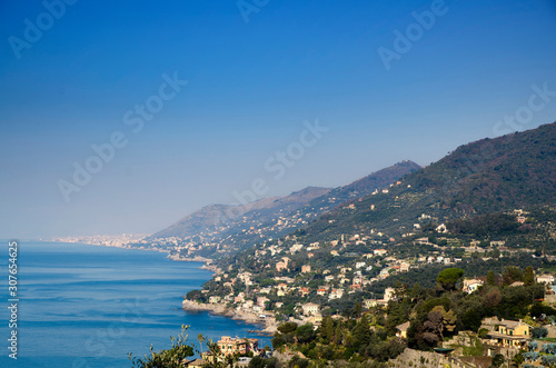 Seacoast with Houses and Blue Sky in a Sunny Day in Liguria, Italy.