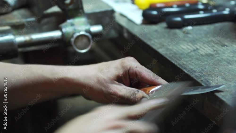 Craftsman making knife with manual labor Craftsman making knife with manual labor