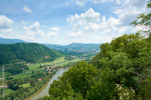 Mountains covered with forests and Mur River Valley Panorama in Graz, Austria. Summer.
