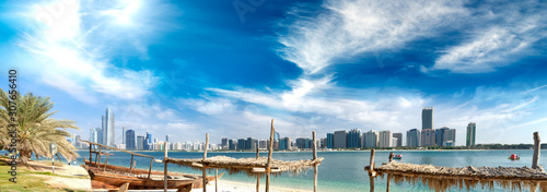 Panoramic view of Abu Dhabi Downtown skyline from the beach at sunset, UAE © jovannig