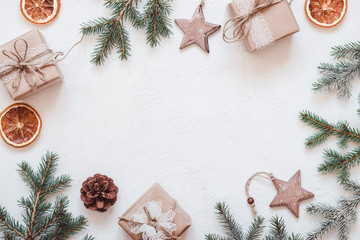 Neutral Christmas frame of fir branches, eco friendly gifts and baubles