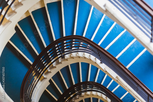 Blue background made for Old blue spiral staircase inside an old house. Color 2020.