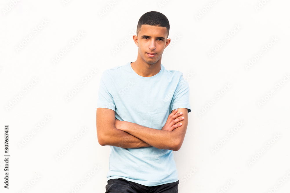 cool young handsome arabic man with arms crossed by white background cool young handsome arabic man with arms crossed by white background