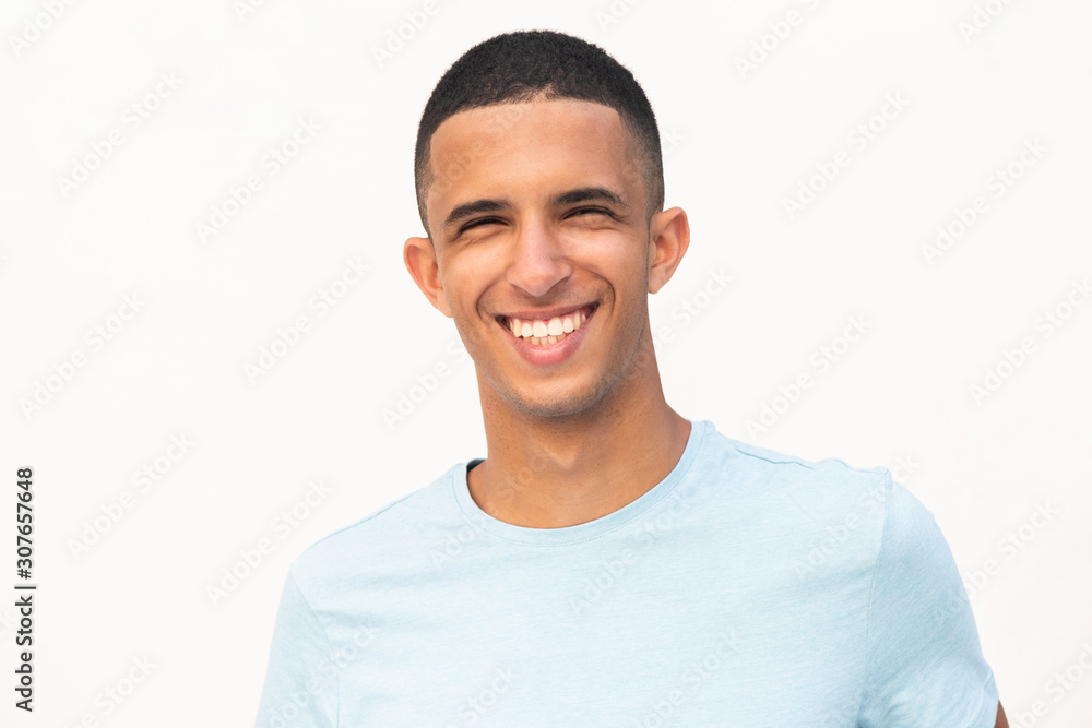 Horizontal portrait of happy smiling young North African man by white background Horizontal portrait of happy smiling young North African man by white background