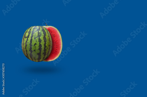 Watermelon on a blue background with copy space. Classic color combination with red and green