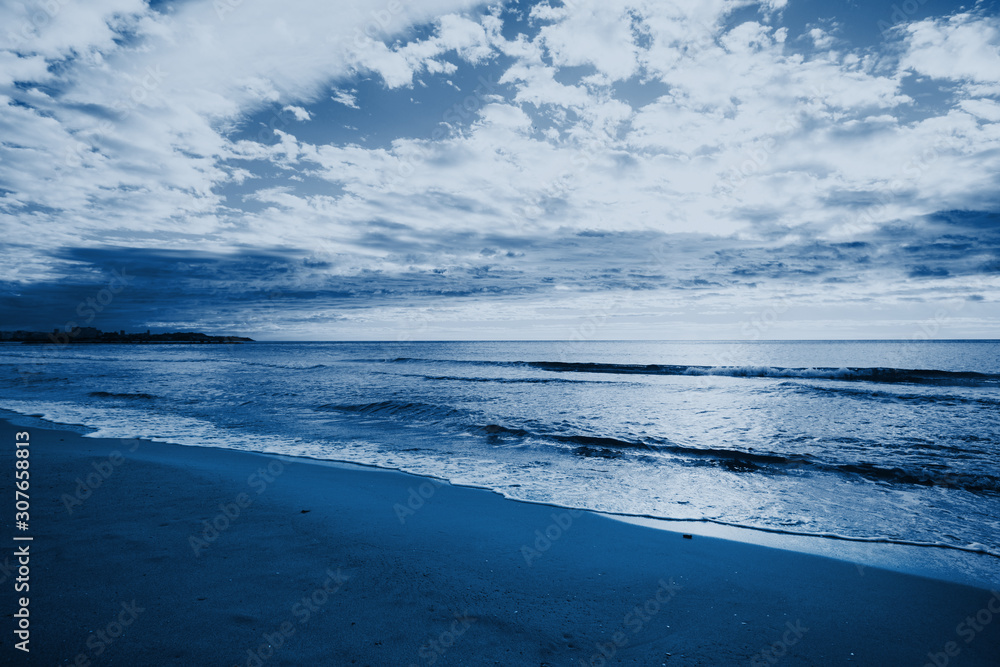 Relaxing seascape with wide horizon of the sky and the sea. Photo toned in modern blue color 2020