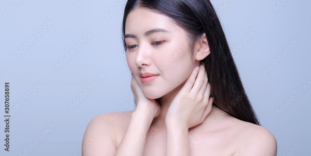 Beauty portrait of a young beautiful woman with hand on her neck shoulder isolated on gray background looking at camera, concept for health , asian beauty model. Beauty portrait of a young beautiful woman with hand on her neck shoulder isolated on gray background looking at camera, concept for health , asian beauty model.