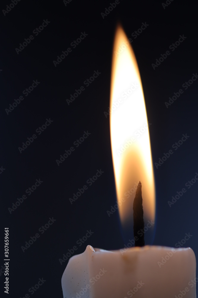 close up burn white candle in the dark close up burn white candle in the dark