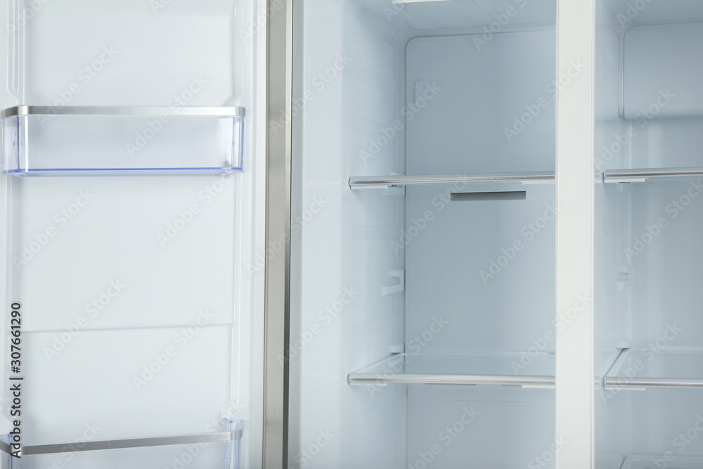 Shelves of empty modern refrigerator, closeup view Shelves of empty modern refrigerator, closeup view