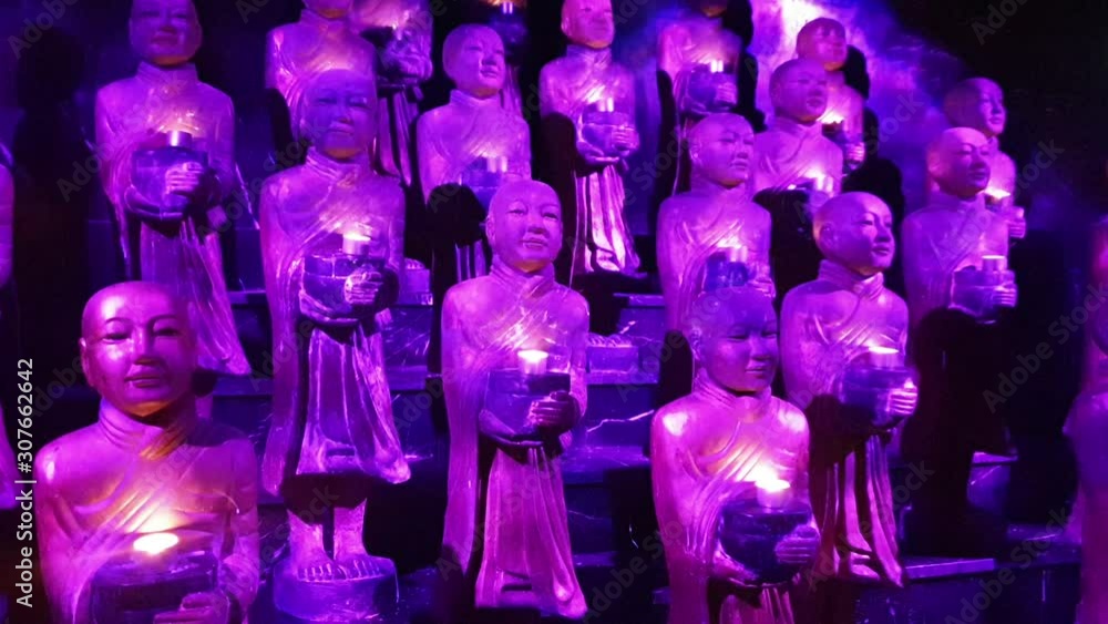 Religious statues with a purple light shining on them Religious statues with a purple light shining on them