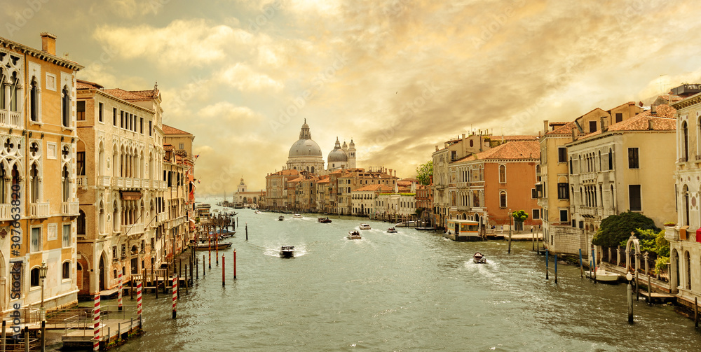 boats navigating in the Grand Canal with church of Santa Maria della Salute in the background, Venice, Italy