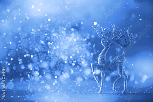 Glitter Christmas deer on mint color background with lights bokeh, copy space. Greeting card for new year party. Trendy classic blue background. Banner