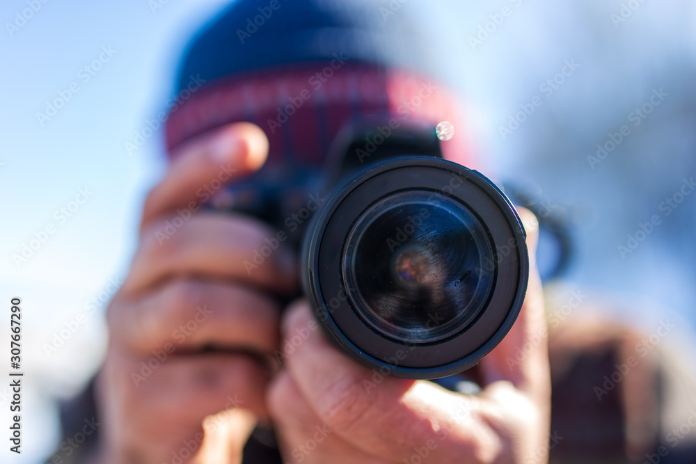 Professional camera in the hands of a man Professional camera in the hands of a man