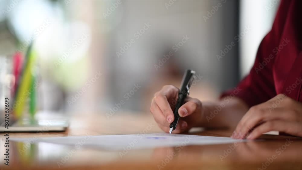Closeup shot sign or writing on contract paper with businesswoman hand writing paper. Closeup shot sign or writing on contract paper with businesswoman hand writing paper.