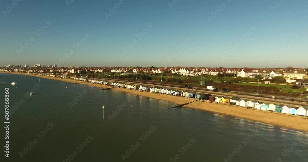 South East Essex coast drone flight 4K. Beach huts then pan to left into the sun, FPV South East Essex coast drone flight 4K. Beach huts then pan to left into the sun, FPV