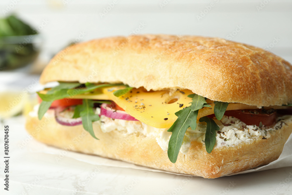 Delicious sandwich with fresh vegetables and cheese on white table, closeup Delicious sandwich with fresh vegetables and cheese on white table, closeup