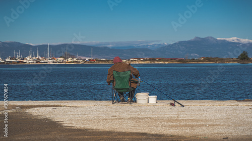fisherman at the marine prepare his fishing pole