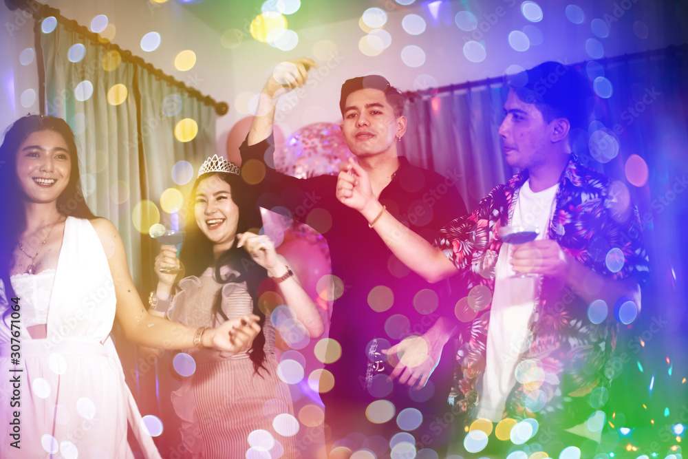 Group of young Asian happy friends having fun at the birthday night party. Group of young Asian happy friends having fun at the birthday night party.
