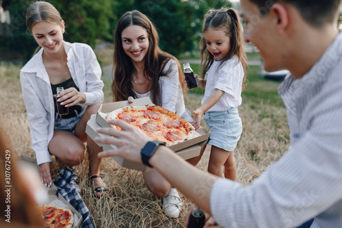 picnic friends with pizza and drinks  sunny day  sunset  company  fun  couples and mom with baby