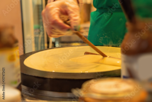 French pancake cooking process. Street food in Paris.