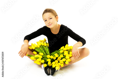 Beautiful little girl gymnast with a bouquet of flowers in the s photo