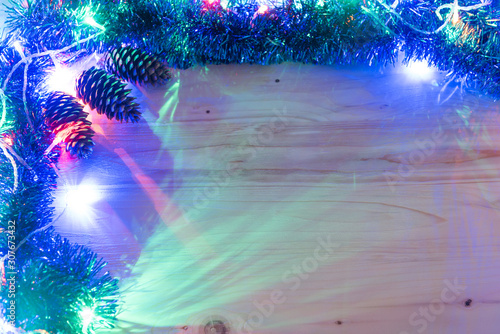 Fototapeta Naklejka Na Ścianę i Meble -  Christmas background. Garland glow on a wooden background. Colored christmas lights background