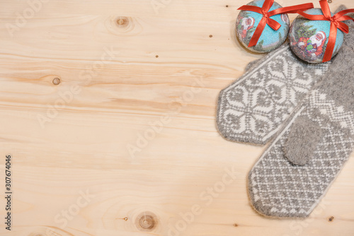 Christmas background. Woolen mittens on a wooden background.