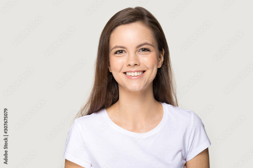 Headshot of happy millennial woman smiling looking at camera Headshot of happy millennial woman smiling looking at camera