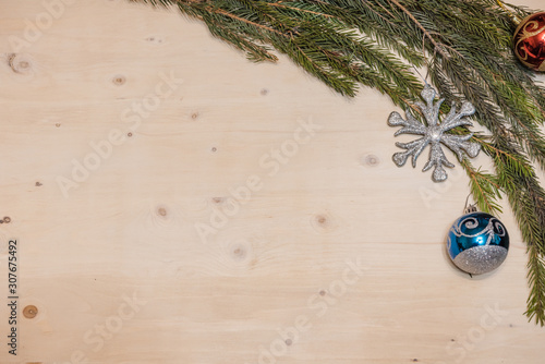 Christmas background. Christmas branch of spruce on a wooden background.