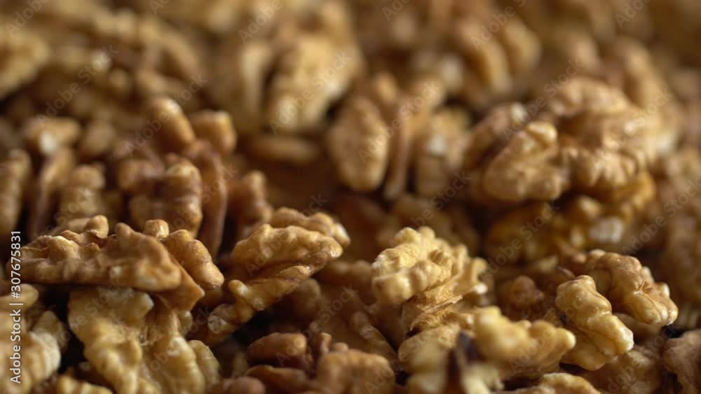 Walnut close up. product rich in minerals and vitamins. Walnut turns in a shot. Walnut kernels rotating. walnut close up lies under beams of the sun. Macro Walnut close up. product rich in minerals and vitamins. Walnut turns in a shot. Walnut kernels rotating. walnut close up lies under beams of the sun. Macro