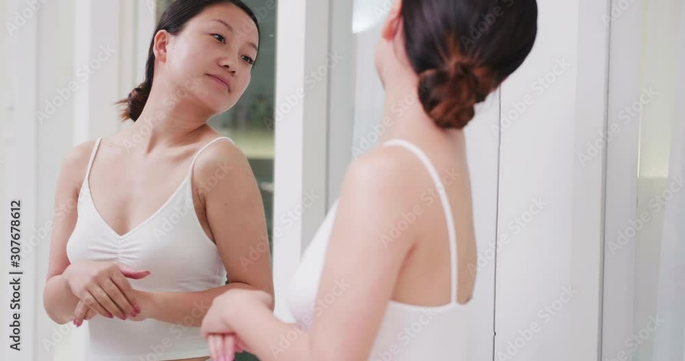 Pretty Young Chinese woman looking in the mirror enjoy her body shape woman like her body Pretty Young Chinese woman looking in the mirror enjoy her body shape woman like her body