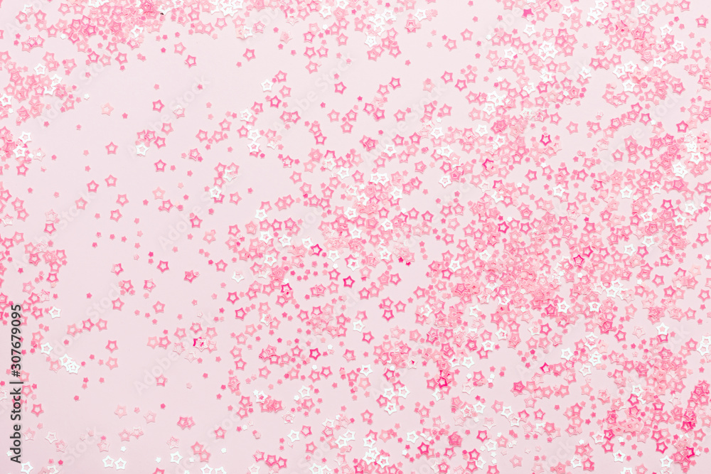 Pink pastel Stars Glitter Confetti on pink background. Festive backdrop