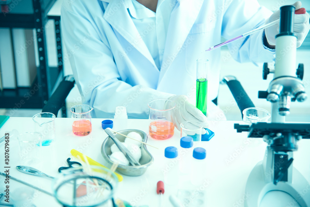 Asian young scientist is researching and testing the use of chemicals for production. See test tubes in science labs, inventions and research concepts. Asian young scientist is researching and testing the use of chemicals for production. See test tubes in science labs, inventions and research concepts.
