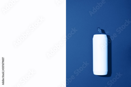 White plastic bottle of cleaning product, household chemicals or liquid laundry detergent on classic blue background. Top view. Flat lay. Copy space. Detergent bottle