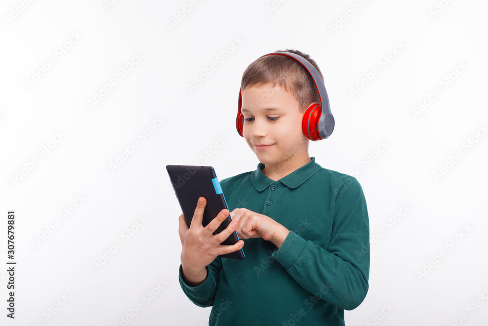 Photo of happy boy using tablet over white background Photo of happy boy using tablet over white background