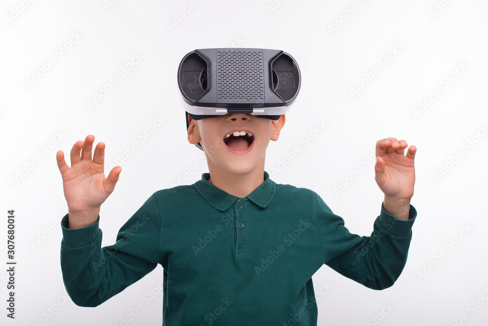 Photo of amazed little boy wearing VR helmet Photo of amazed little boy wearing VR helmet