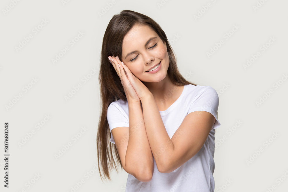 Headshot of smiling young woman sleeping with eyes closed Headshot of smiling young woman sleeping with eyes closed